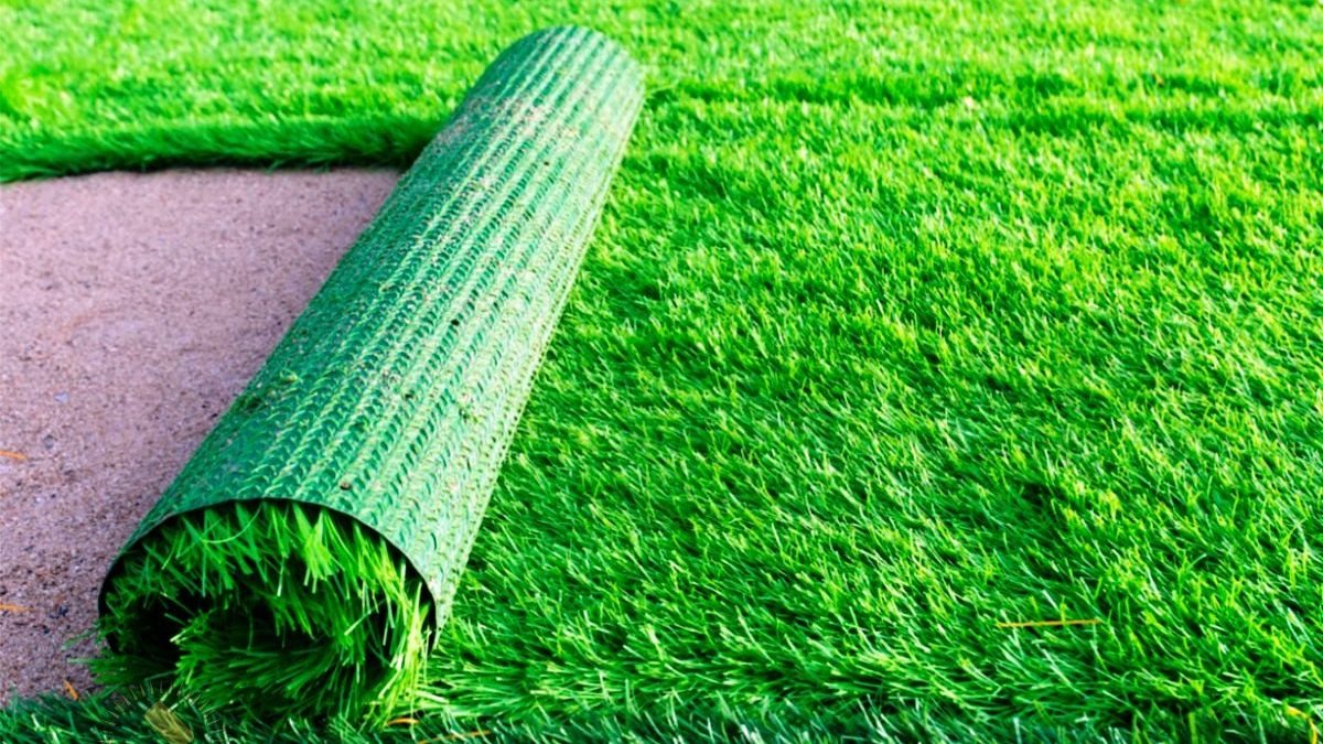 Premium artificial grass from Al Ameen Carpets, creating a lush green look for indoor and outdoor spaces like gardens and balconies.