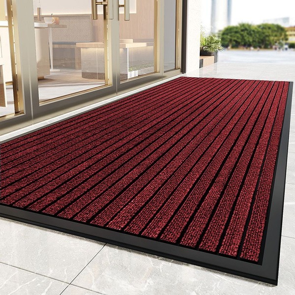 A stylish, high-quality door mat placed at an entrance, combining functionality and elegance to welcome guests.